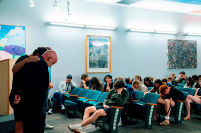 students praying over Vance Freeman at LMFA